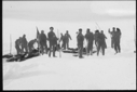 Image of Sealers with poles and dead seals on snow